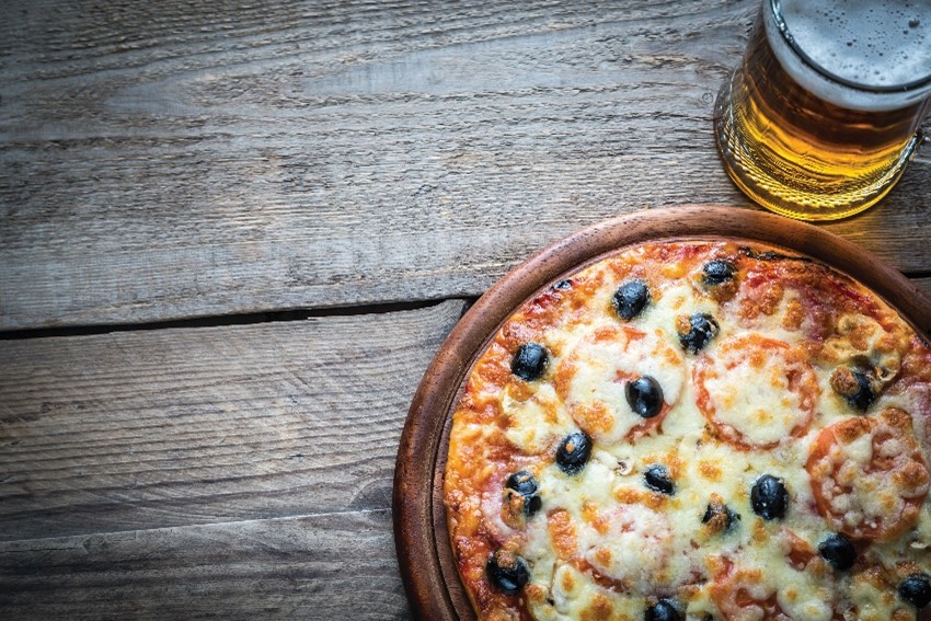 A pizza and beer on a wooden table