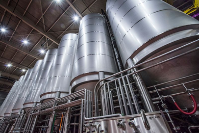 A photo of fermentation tanks in a brewery.